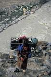 A porter carries a bulky load on day 1 of the trek to the Baltoro Glacier