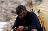 Olivier Dufresne passes the time by reading in Broad Peak base camp